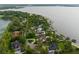 Aerial view of a large waterfront estate with a pool, boat dock and lush landscaping at 1455 Kelso Blvd, Windermere, FL 34786