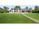 Sprawling backyard with lush lawn and patio features elegant architecture, ideal for outdoor enjoyment at 1455 Kelso Blvd, Windermere, FL 34786
