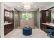 This primary bathroom offers two vanities, a glass shower, and natural lighting at 1455 Kelso Blvd, Windermere, FL 34786