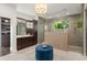 The bathroom features dual showers, a vanity, and a blue sitting stool at 1455 Kelso Blvd, Windermere, FL 34786