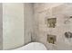 Close up of walk in shower area, featuring a modern design and neutral colored tiling at 1455 Kelso Blvd, Windermere, FL 34786