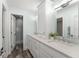 Bright bathroom featuring double sinks and a glass door to a walk in shower at 1455 Kelso Blvd, Windermere, FL 34786