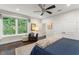 Comfortable bedroom with hardwood floors, large window, and a cozy sitting area with lamps at 1455 Kelso Blvd, Windermere, FL 34786