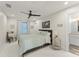 Comfortable bedroom with a ceiling fan, full bed, and a view to the ensuite bathroom at 1455 Kelso Blvd, Windermere, FL 34786