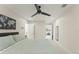 Large bedroom featuring neutral colors, ceiling fan, full bed, and ensuite access at 1455 Kelso Blvd, Windermere, FL 34786