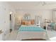Cozy bedroom with a bright color scheme, full bed, desk area, and ensuite bathroom at 1455 Kelso Blvd, Windermere, FL 34786