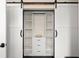 Well-organized closet features shelving and drawers behind sliding barn doors for efficient storage at 1455 Kelso Blvd, Windermere, FL 34786