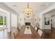 Traditional dining room featuring a fireplace, elegant chandelier, and a large table with seating for 10 at 1455 Kelso Blvd, Windermere, FL 34786