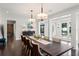 Formal dining room with wood floors, modern lighting, and seating for eight at 1455 Kelso Blvd, Windermere, FL 34786