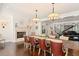 Traditional dining room with fireplace, seating for 10, and grand piano in living room at 1455 Kelso Blvd, Windermere, FL 34786