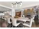 Open-concept dining room featuring modern lighting fixtures and view to great room at 1455 Kelso Blvd, Windermere, FL 34786