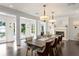 Spacious dining room featuring a fireplace, wood floors, and access to the outdoors at 1455 Kelso Blvd, Windermere, FL 34786