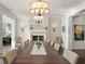 Open-concept dining room with wood floors, a fireplace, and stylish decor at 1455 Kelso Blvd, Windermere, FL 34786