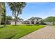 Elegant home with a brick driveway, manicured lawn, and a three-car garage on a sunny day at 1455 Kelso Blvd, Windermere, FL 34786
