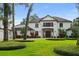 Stunning home with lush landscaping, mature trees, and a grand double-door entrance at 1455 Kelso Blvd, Windermere, FL 34786