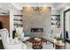 Cozy great room showcasing a modern fireplace, comfortable seating, and custom shelving at 1455 Kelso Blvd, Windermere, FL 34786