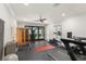 Spacious home gym with a sauna, modern equipment, and sliding glass doors to the exterior and a view of the water at 1455 Kelso Blvd, Windermere, FL 34786