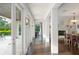 Hallway with French doors, wood floors, and views of outdoor greenery and a fireplace at 1455 Kelso Blvd, Windermere, FL 34786