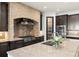 Close-up of the kitchen featuring a stone backsplash, stainless appliances, and granite countertops at 1455 Kelso Blvd, Windermere, FL 34786