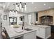 Open kitchen with granite countertops, pendant lighting, and an eat-in breakfast bar at 1455 Kelso Blvd, Windermere, FL 34786