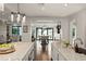 Open kitchen with large island offers view to dining area and water view at 1455 Kelso Blvd, Windermere, FL 34786