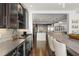 Kitchen bar and view of the kitchen with custom wine storage and stainless-steel appliances at 1455 Kelso Blvd, Windermere, FL 34786