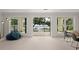 Spacious living area with large windows offering views of the lake, and a comfortable beanbag at 1455 Kelso Blvd, Windermere, FL 34786