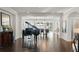A view from the living room with beautiful hardwood floors looking into an open dining area with lake views at 1455 Kelso Blvd, Windermere, FL 34786