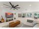 Spacious living room with a large TV, ceiling fan and access to an outdoor area at 1455 Kelso Blvd, Windermere, FL 34786