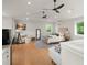 Bright living space boasts hardwood floors, a cozy sitting area, and large windows with scenic views at 1455 Kelso Blvd, Windermere, FL 34786