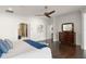 This main bedroom offers dark wood floors, white walls, and a ceiling fan at 1455 Kelso Blvd, Windermere, FL 34786