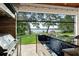 Well equipped outdoor kitchen overlooking lush green lawn and a tranquil lake at 1455 Kelso Blvd, Windermere, FL 34786
