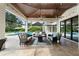 Covered patio features comfortable seating, a ceiling fan, and a view of the pool and backyard at 1455 Kelso Blvd, Windermere, FL 34786