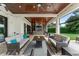 Beautiful covered patio with comfortable seating and an outdoor fireplace creating a relaxing space at 1455 Kelso Blvd, Windermere, FL 34786