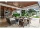 Inviting covered patio with outdoor seating, fireplace, TV, and scenic views at 1455 Kelso Blvd, Windermere, FL 34786