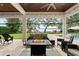 Cozy outdoor patio with fireplace, comfortable seating, and picturesque lake views at 1455 Kelso Blvd, Windermere, FL 34786