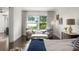 Cozy sitting area with comfortable chairs, side table, and serene waterfront views at 1455 Kelso Blvd, Windermere, FL 34786