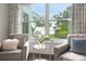 Intimate sitting area showcasing water views, stylish decor, and natural light at 1455 Kelso Blvd, Windermere, FL 34786
