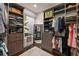 Walk-in closet with custom shelving, mirror, and a window for natural light at 1455 Kelso Blvd, Windermere, FL 34786