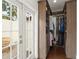 Walk-in closet with wood shelving and a door to the outdoor patio at 1455 Kelso Blvd, Windermere, FL 34786