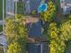 Aerial view of the home showcasing the roof, landscaping, and the neighborhood, including a community pool at 146 Tollgate Trl, Longwood, FL 32750