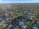 An aerial view showcases lush trees, winding roads, and houses with private pools at 146 Tollgate Trl, Longwood, FL 32750