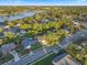Aerial view showcasing the property within a leafy neighborhood near a scenic lake, highlighting community features at 146 Tollgate Trl, Longwood, FL 32750