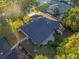 A bird's eye view showcases the home's roof, backyard patio, lush greenery, and a small shed at 146 Tollgate Trl, Longwood, FL 32750