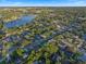 Aerial view showcasing a scenic neighborhood near a lake, featuring tree-lined streets at 146 Tollgate Trl, Longwood, FL 32750
