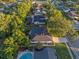 An aerial view of a home in a neighborhood with mature trees and a private backyard pool at 146 Tollgate Trl, Longwood, FL 32750