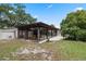 Backyard featuring a sunroom, mature trees, a mini-split system, and a green lawn at 146 Tollgate Trl, Longwood, FL 32750