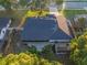 Aerial view of backyard with a lush lawn, mature trees, patio, and full privacy fence at 146 Tollgate Trl, Longwood, FL 32750