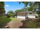 Backyard featuring a storage shed, fence, and lush green grass under a bright sky at 146 Tollgate Trl, Longwood, FL 32750