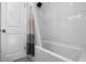 Bathtub with white tiled wall and decorative shower curtain at 146 Tollgate Trl, Longwood, FL 32750